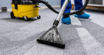Photo Of Janitor Cleaning Carpet With Vacuum Cleaner